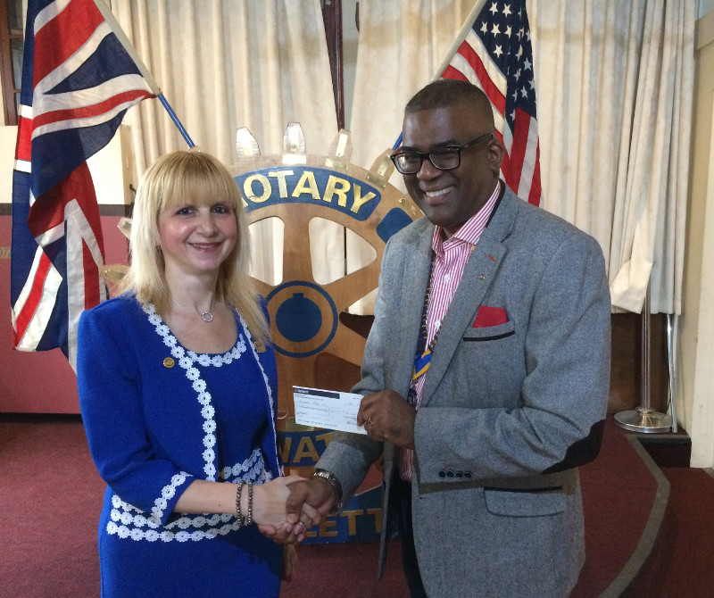 The President of the Rotary Club of Radlett Mr Clive Daley presenting a cheque to Lisa Chairman of Dementia Club UK