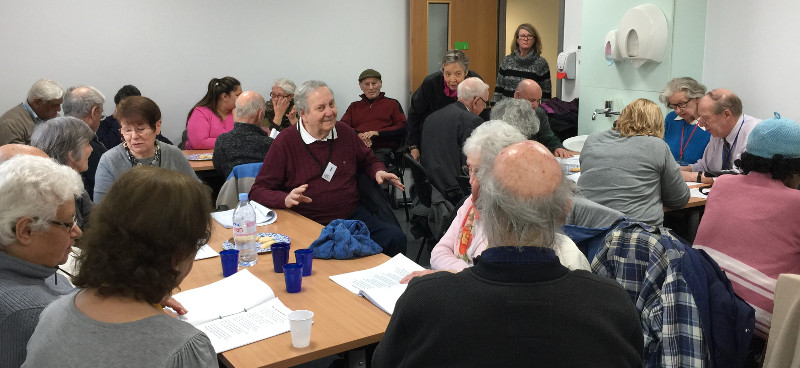 Members of Dementia Club UK conentrating on their song sheets