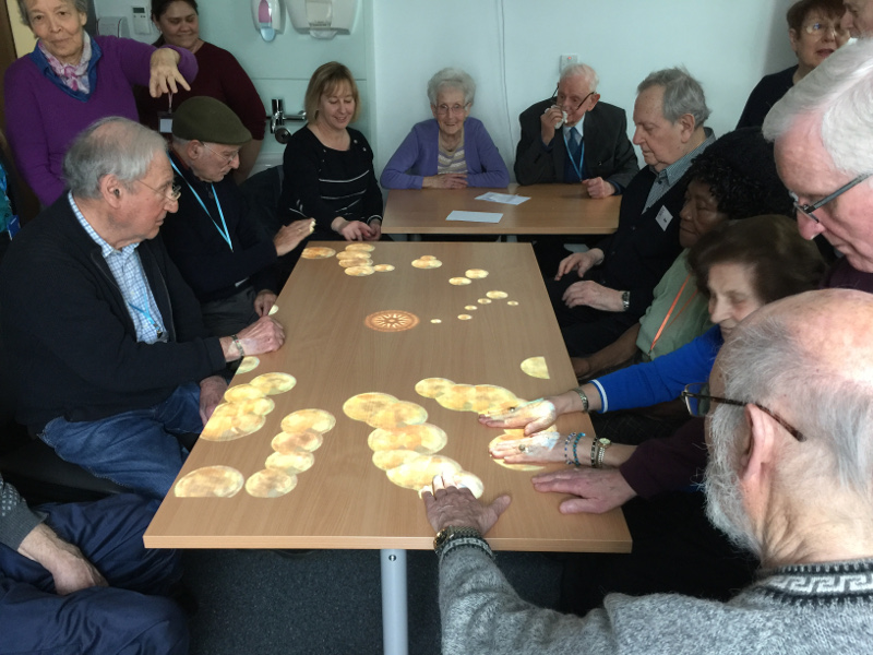 Members of Dementia Club UK enjoying the games on the Tovertafel (Magic Table)