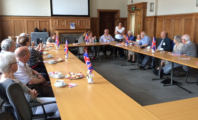 Dementia Club UK members singing 'Happy Birthday' at Hendon Town Hall, Union Jack flahs are to celebrate the GB teams Olympic medals