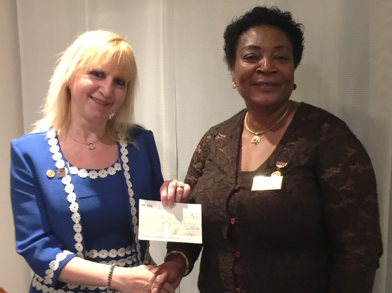 Eugenia Dike President of the Rotary Club of Hendon presenting a cheque to Lisa