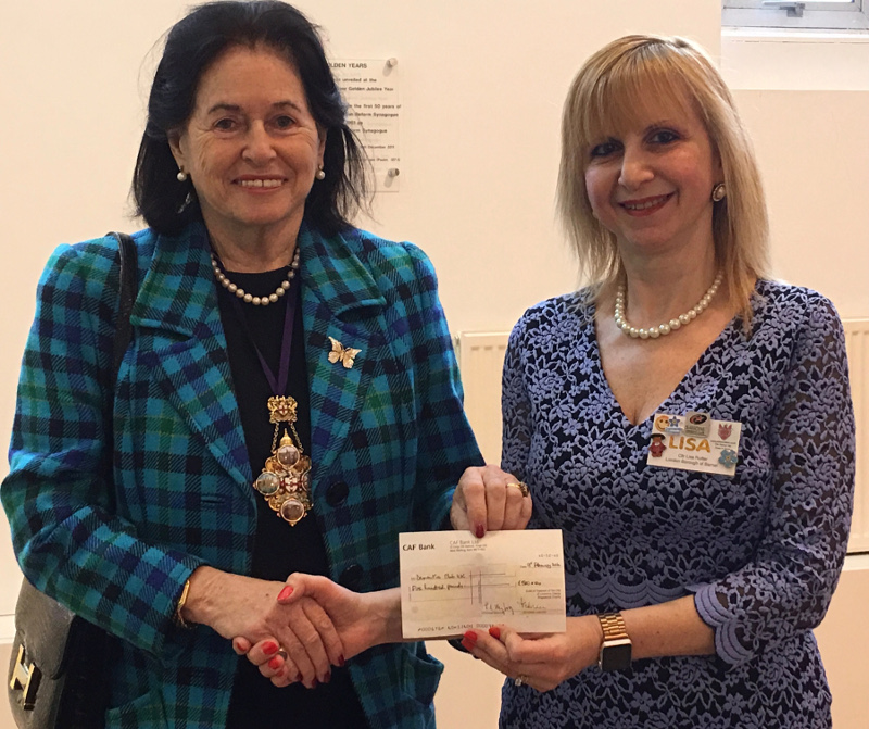 Cllr Lisa Rutter receiving a cheque from Lady Poppy Cooksey for Dementia Club UK