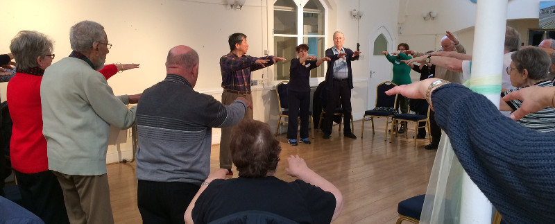 Members of Dementia Club UK using Tai Chi to exercise