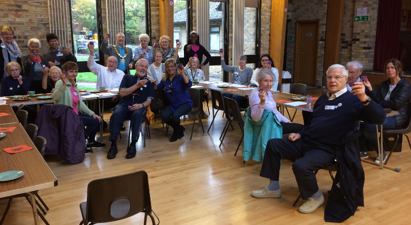 Members holding up purple cup cakes baked by Sasha to celebrate Rotary's fight against Polio