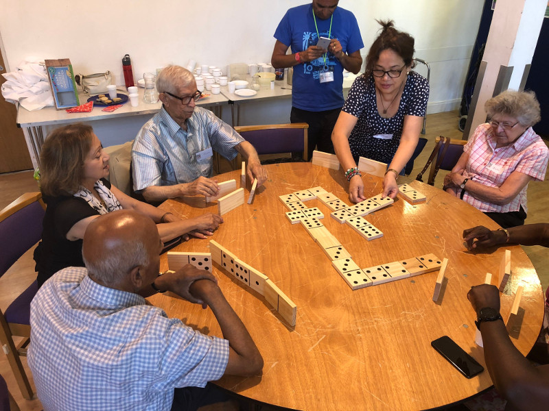 Lots of concentration around the dominoes game