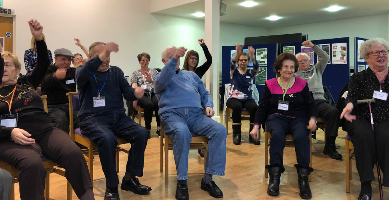 Dementia Club UK members doing chair exercises led by Jane