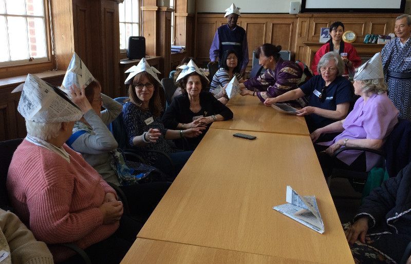 Members trying on their Origami Hats